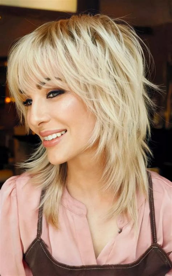 Discover the Charm of Medium Length Low Maintenance Shaggy Haircut with Bangs: A Trendy Choice for Effortless Style
